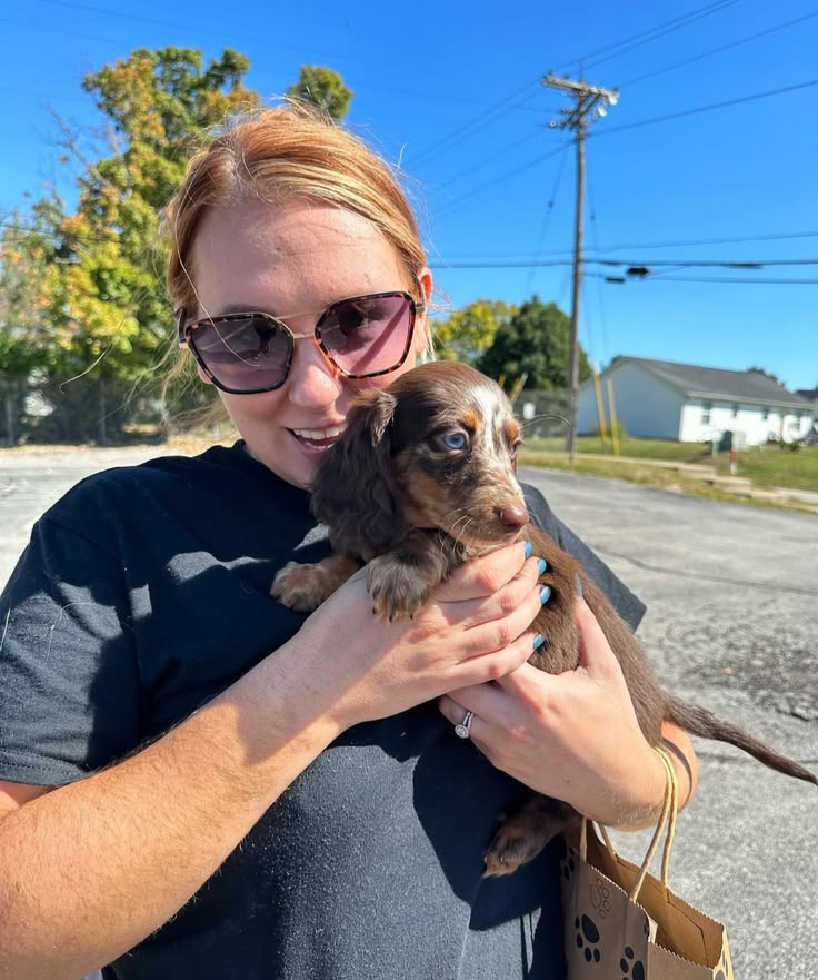 Cheryl holding dachshund puppy